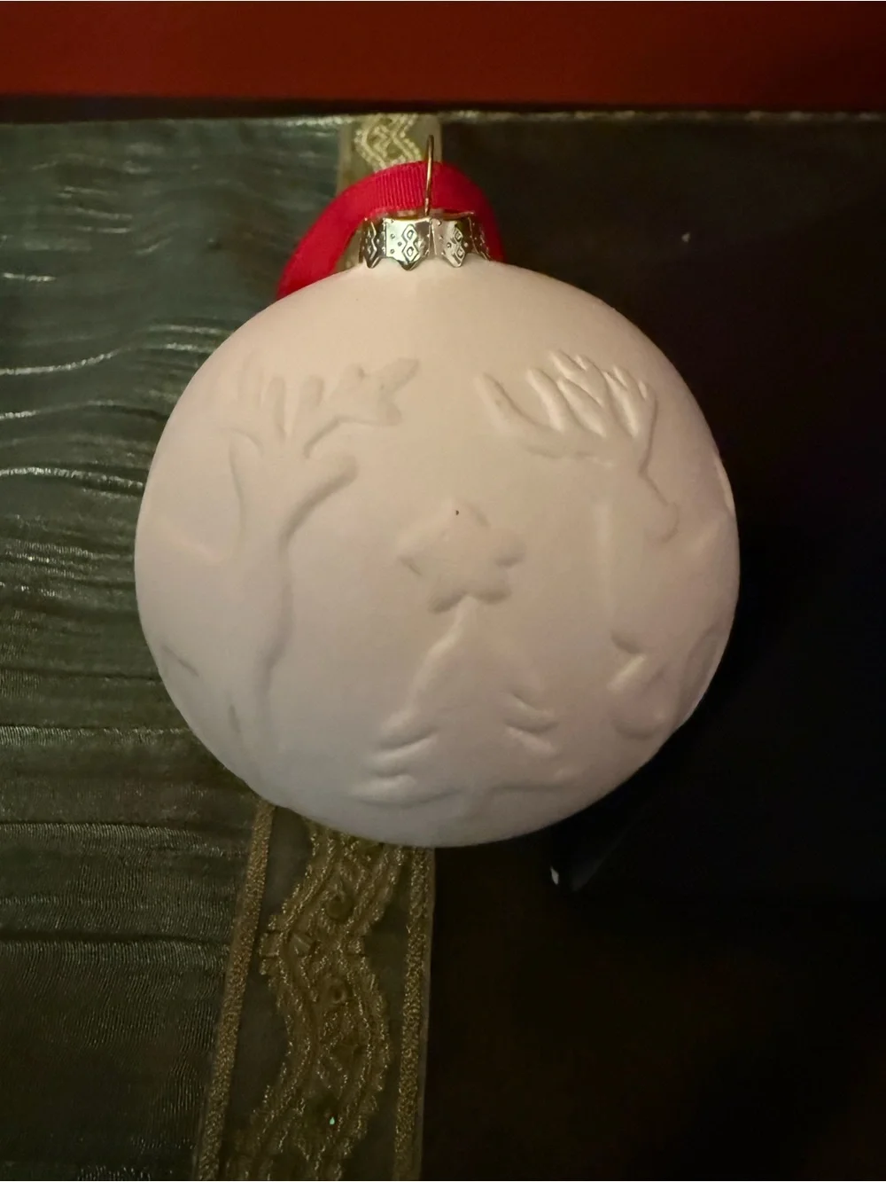 White Embossed Holiday Ornament with Red Ribbon